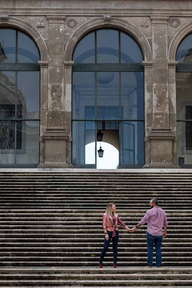 Walking hand in hand and standing on top of a large staircase