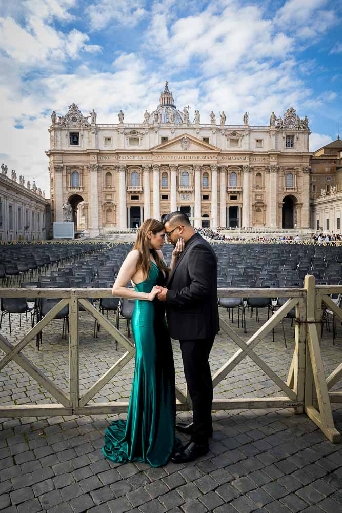 Posed portrait picture of couple taking pictures in front of Saint Peter's Basilica in Rome's Vatican square