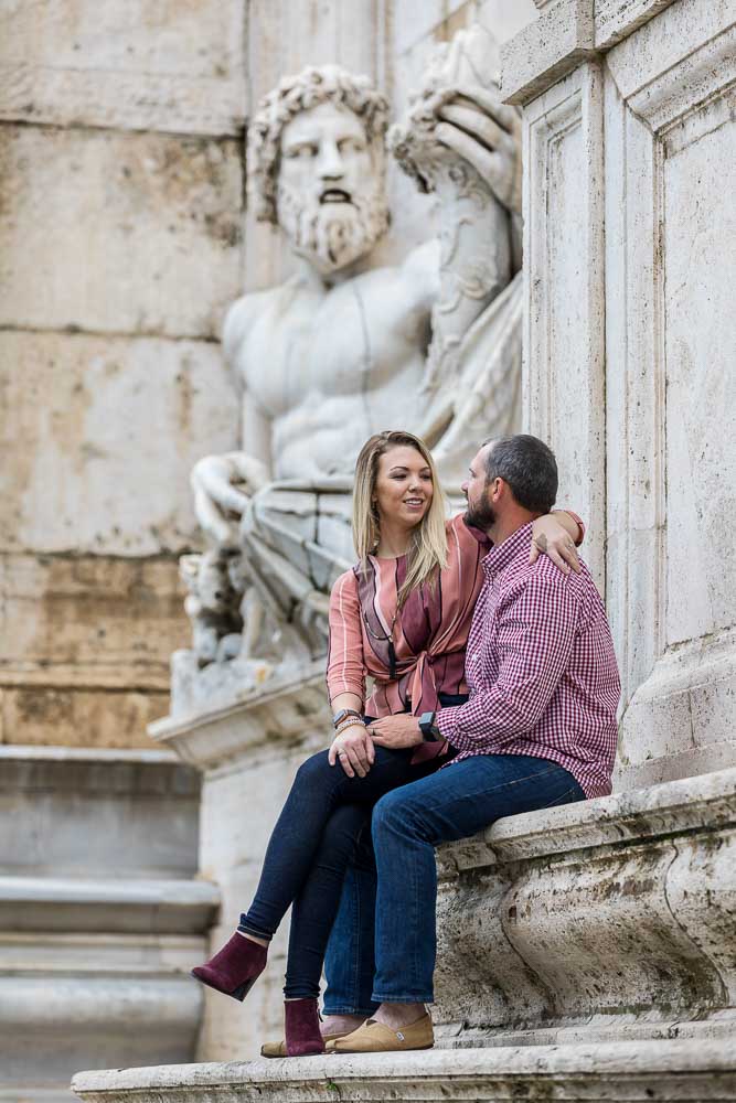 Roman couple portrait sitting down before a large marble statue