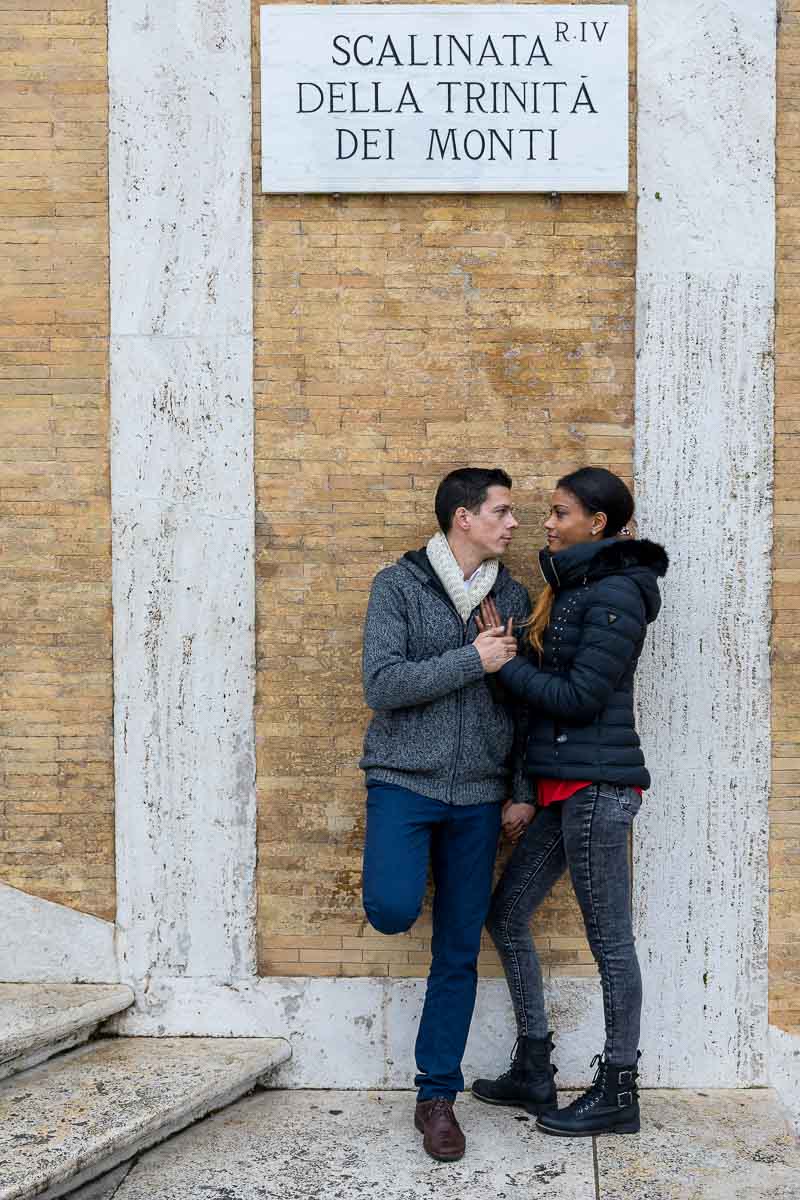 Standing underneath the Trinita dei Monti marble sign and steps