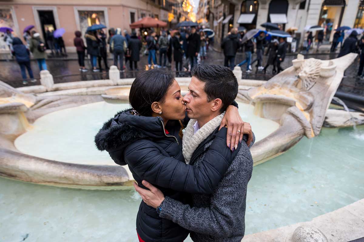 Love story photo session by the Barcaccia water fountain found at the foot of the Spanish Steps