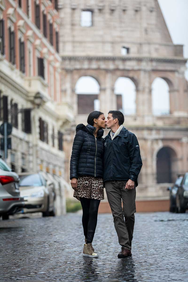 Walking in Rome during a photoshoot on cobblestone alleyway streets with the Colosseum in the background