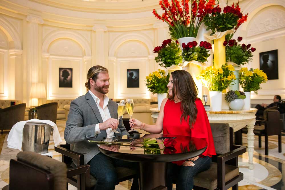 Couple toasting with cool sparkling wine to celebrate their engagement