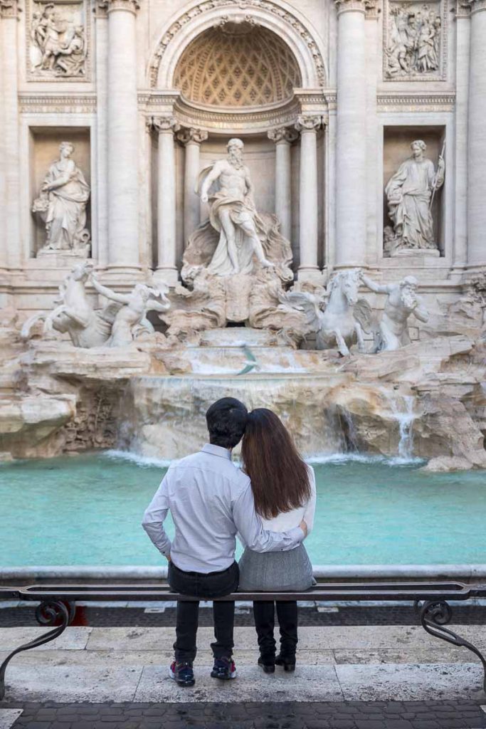 Sitting down romantic photo of being together in Rome Italy admiring some of the beautiful landmarks like Trevi fountain