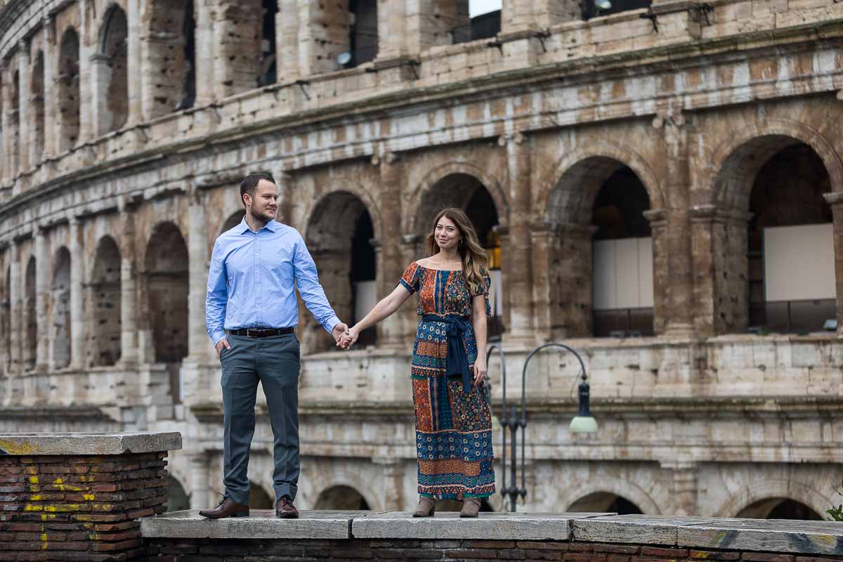 Holding hands in front of the Roman Colosseum