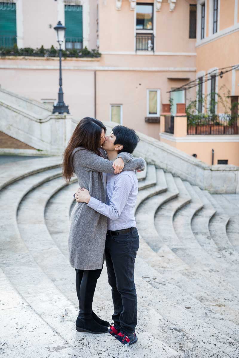 Couple kissing in the middle of the Spanish steps with the geometrical effect leading away