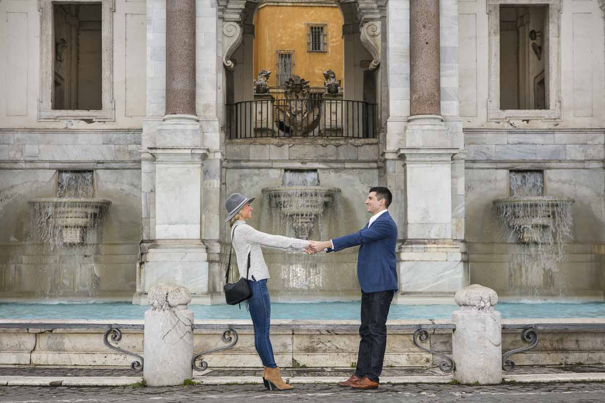 Posing holding hands in front of the Fontanone water fountain