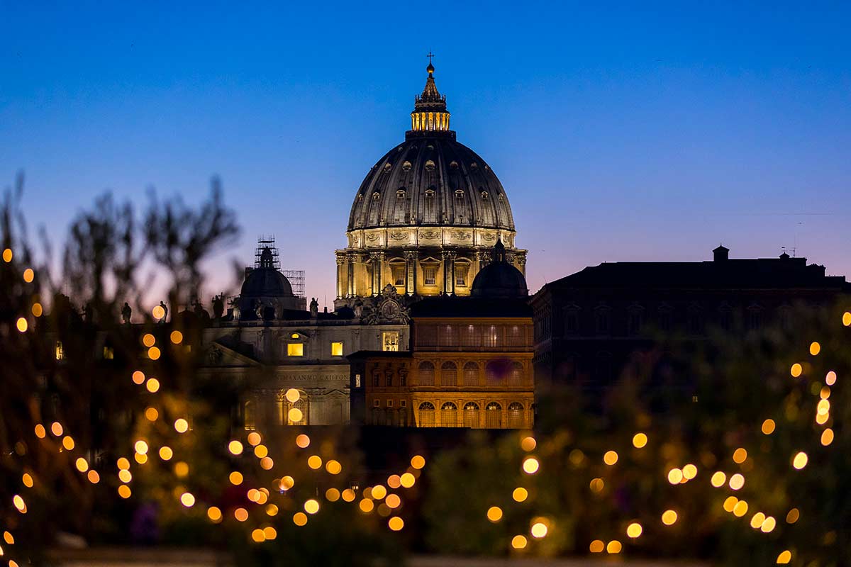 View of Saint Peter's dome at dusk with Christmas lights