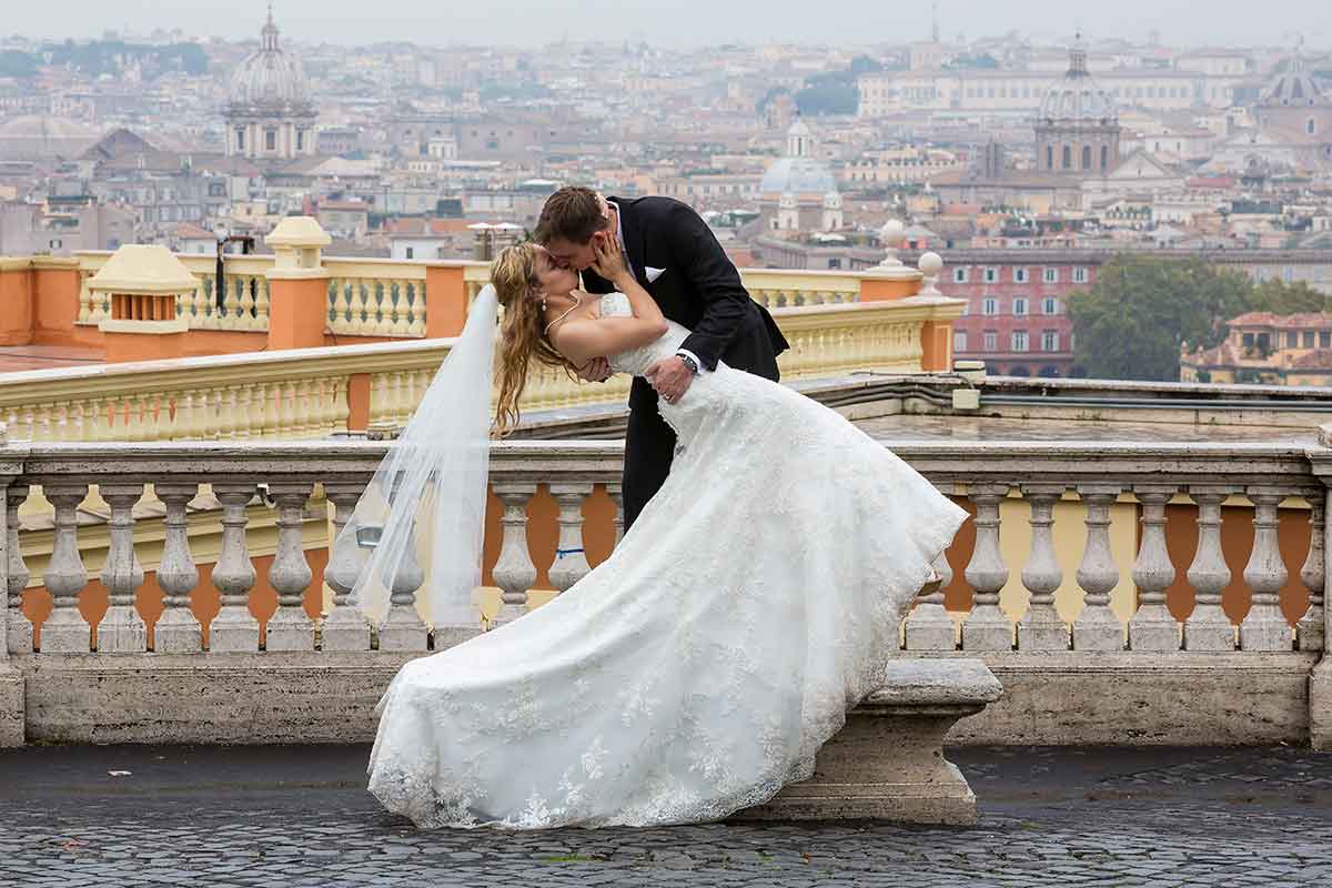 Bride and groom during their big day photographed with the Eternal city in the background. Wedding Photographer Rome Service. 