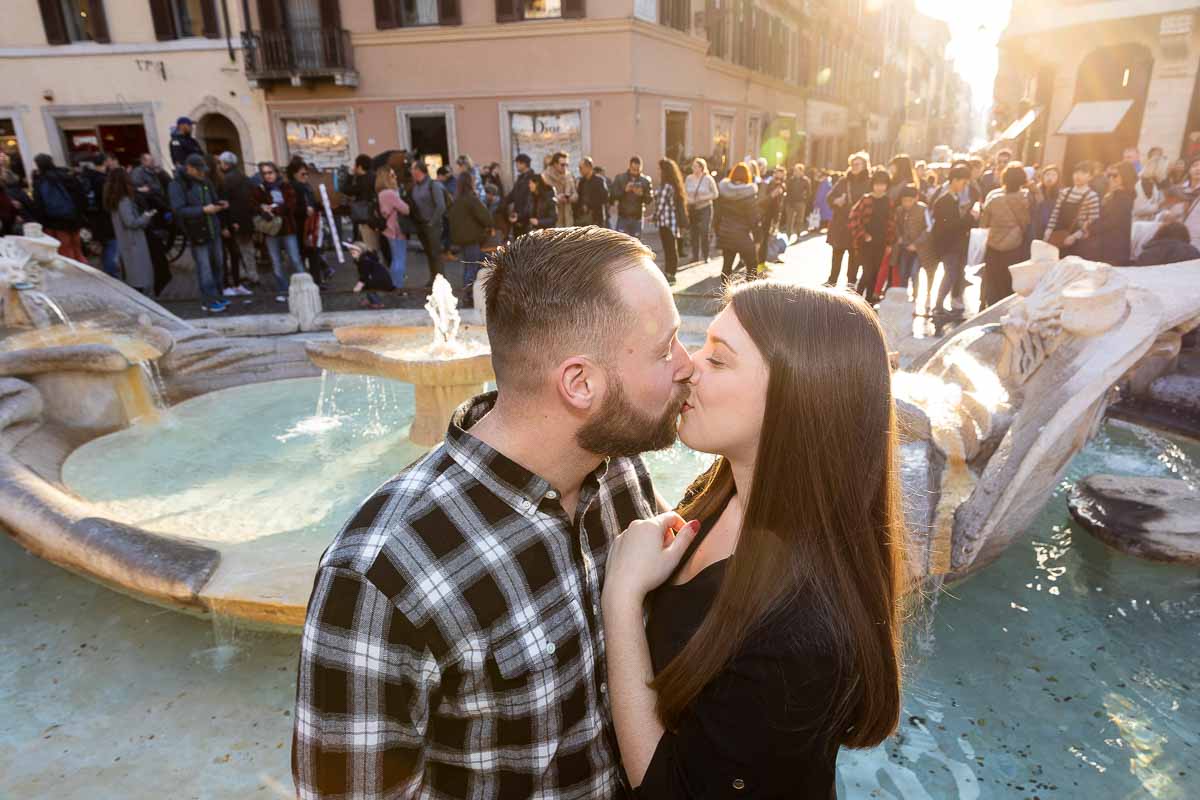 Kissing by the Barcaccia water fountain with sunsetting light