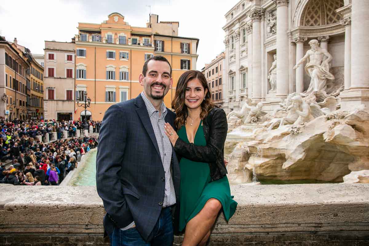 Posed couple portrait taken in front of the Trevi fountain from a high point