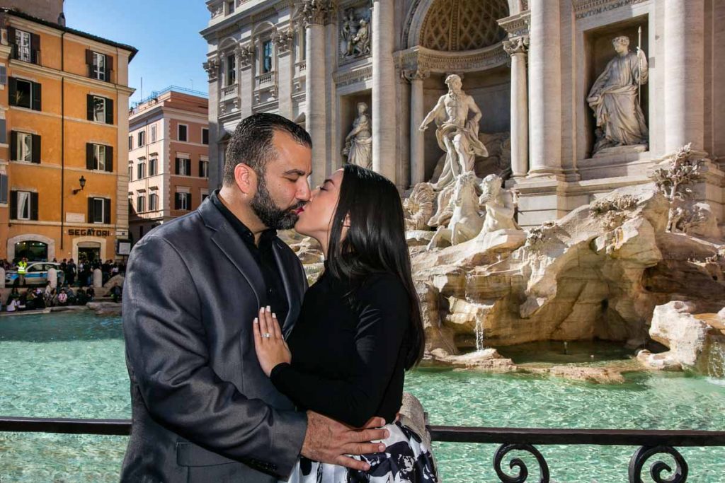 Couple kissing during an Engagement photoshoot at the Trevi fountain in Rome Italy by the Andrea Matone photographer studio