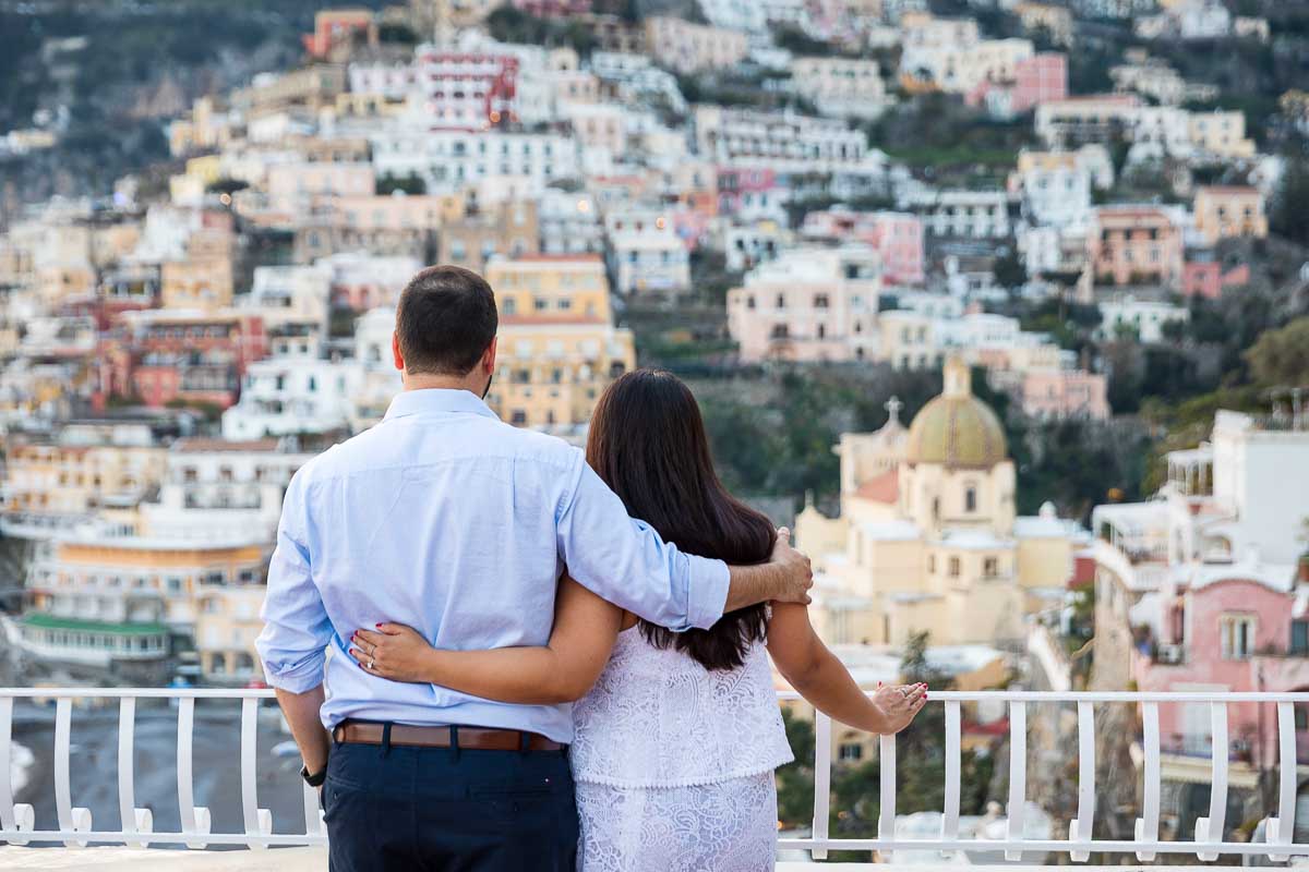 Couple close together looking at Positano's view. Surprise Wedding Proposal Photography 