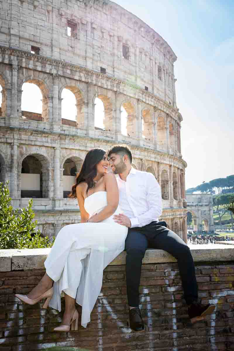 Newlywed couple having fun at the Roman Colosseum in Rome Italy