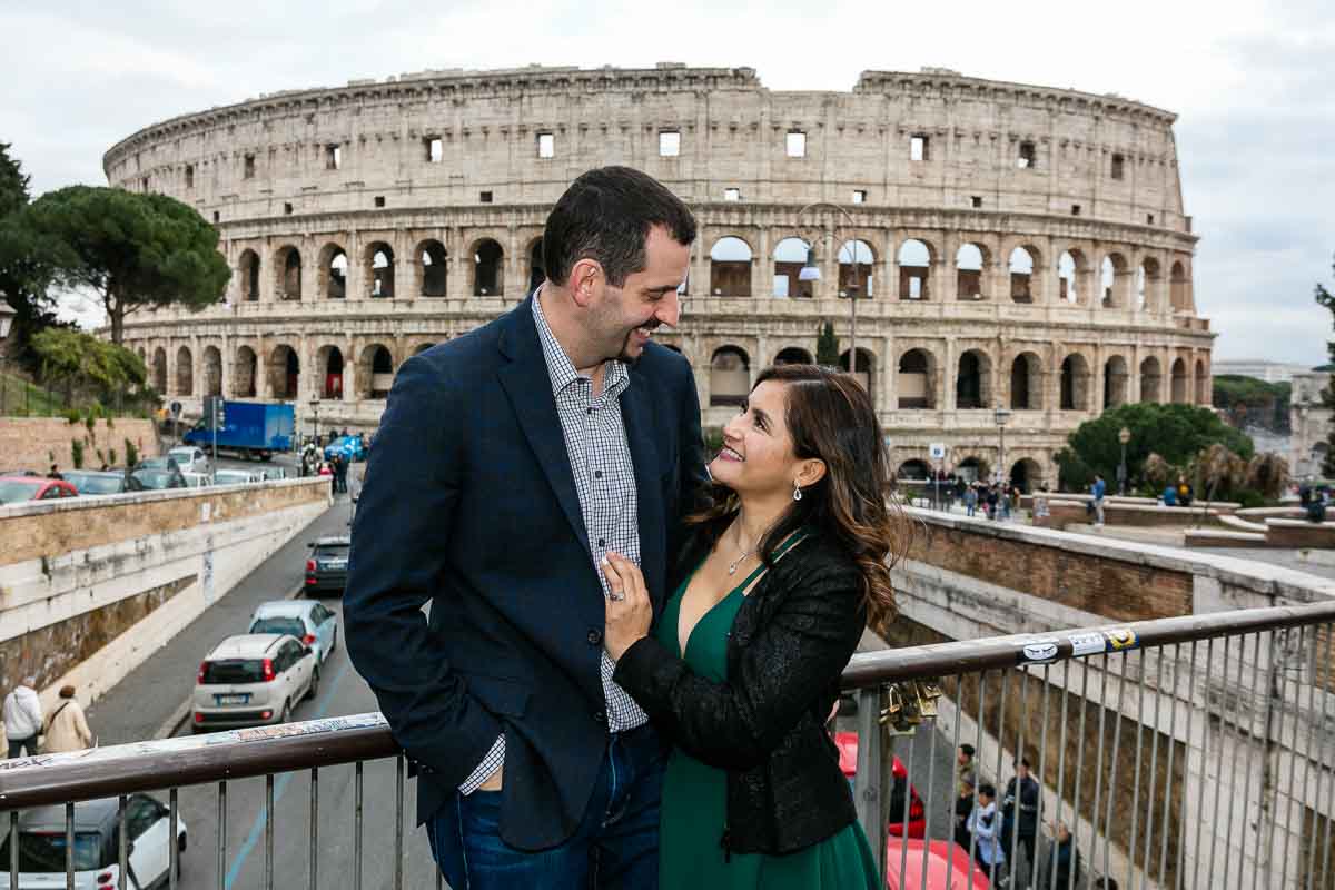 Looking at each other while posing for a picture in front of the roman coliseum