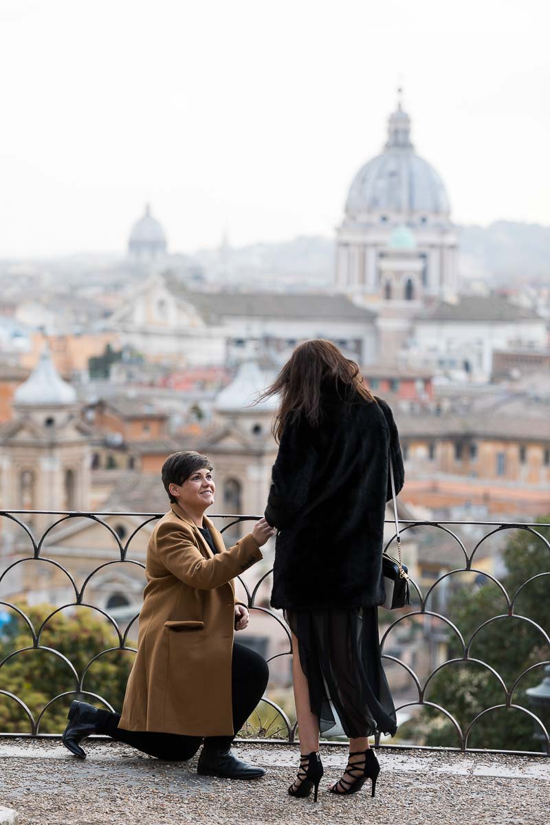 Same sex wedding marriage proposal photographed at a park terrace overlooking the city from afar