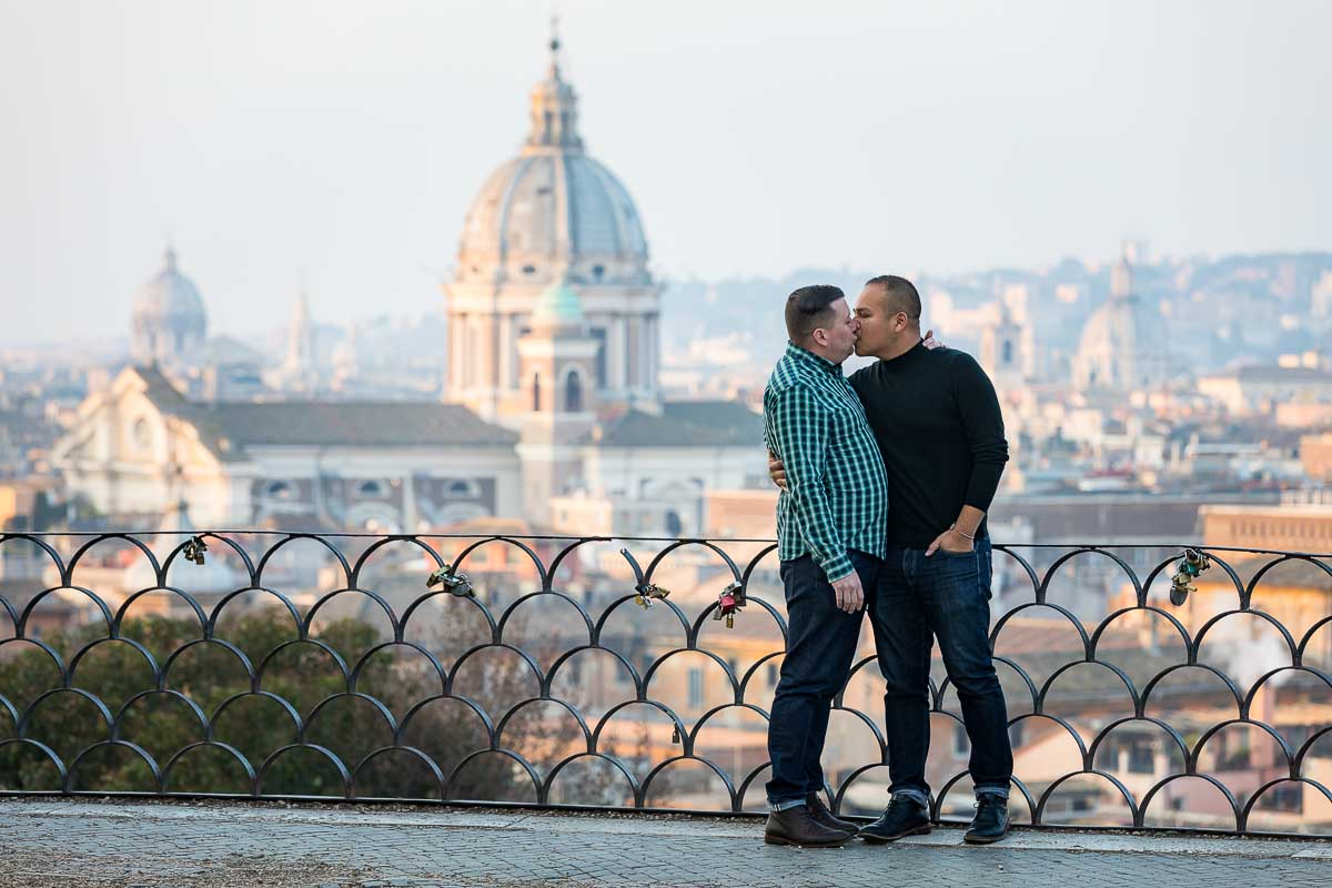 Kissing at the terrace of Parco del Pincio during an engagement photography session