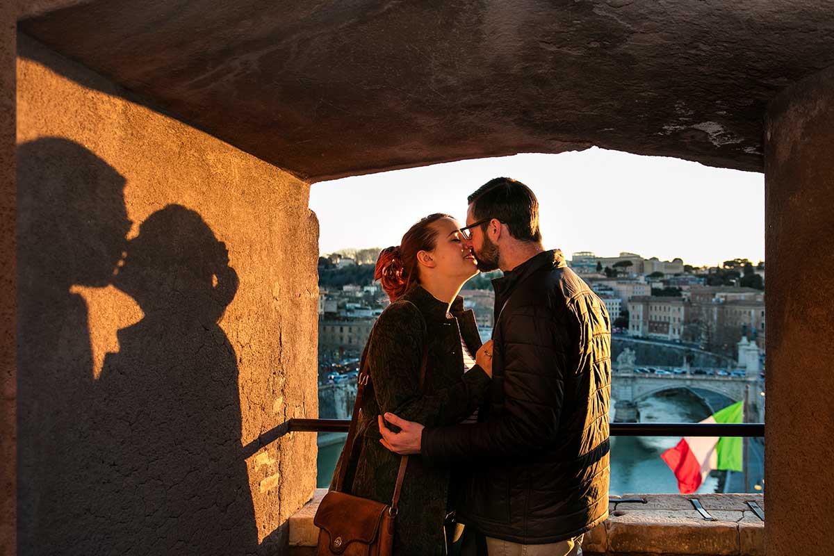 Couple kissing during a photoshoot on the Castel Sant'Angelo terrace in Rome Italy