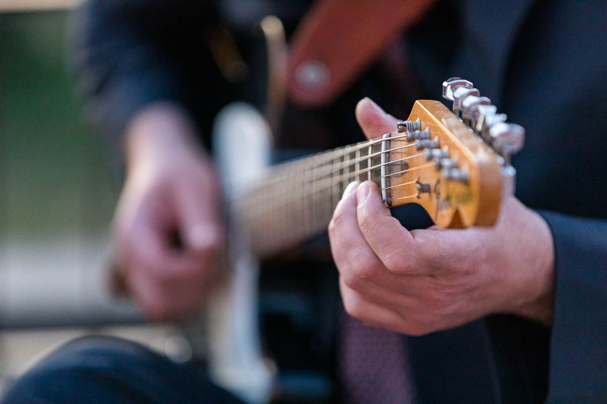 Close up man playing electric guitar