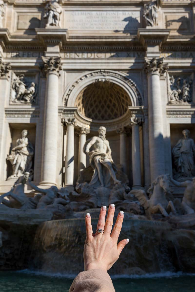 The engagement ring against the statues of the Trevi fountain