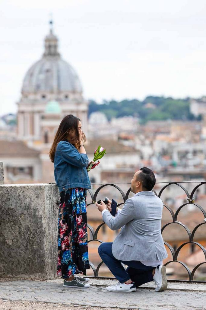 Surprise wedding proposal taking place at the scenic terrace view of Parco del Pincio in the Villa Borghese gardens of Rome Italy