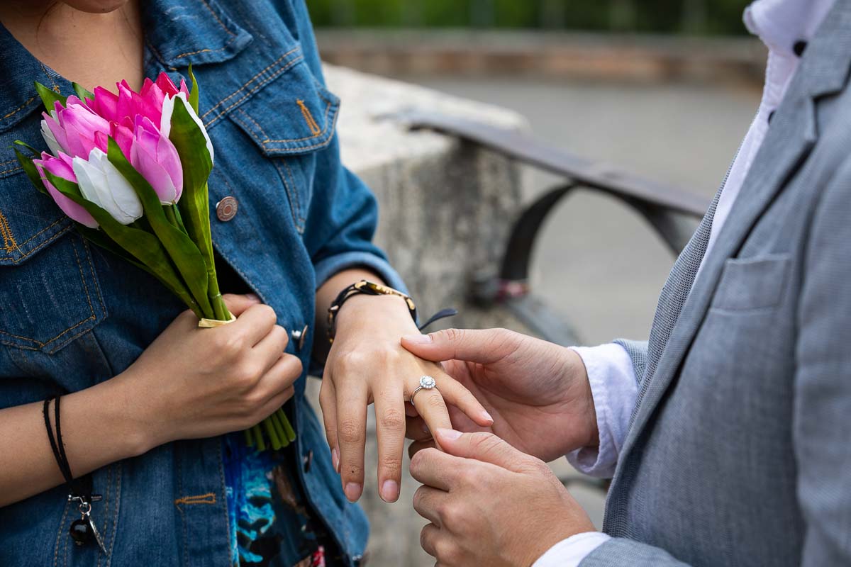 Close up image of the engagement ring. Putting on the ring