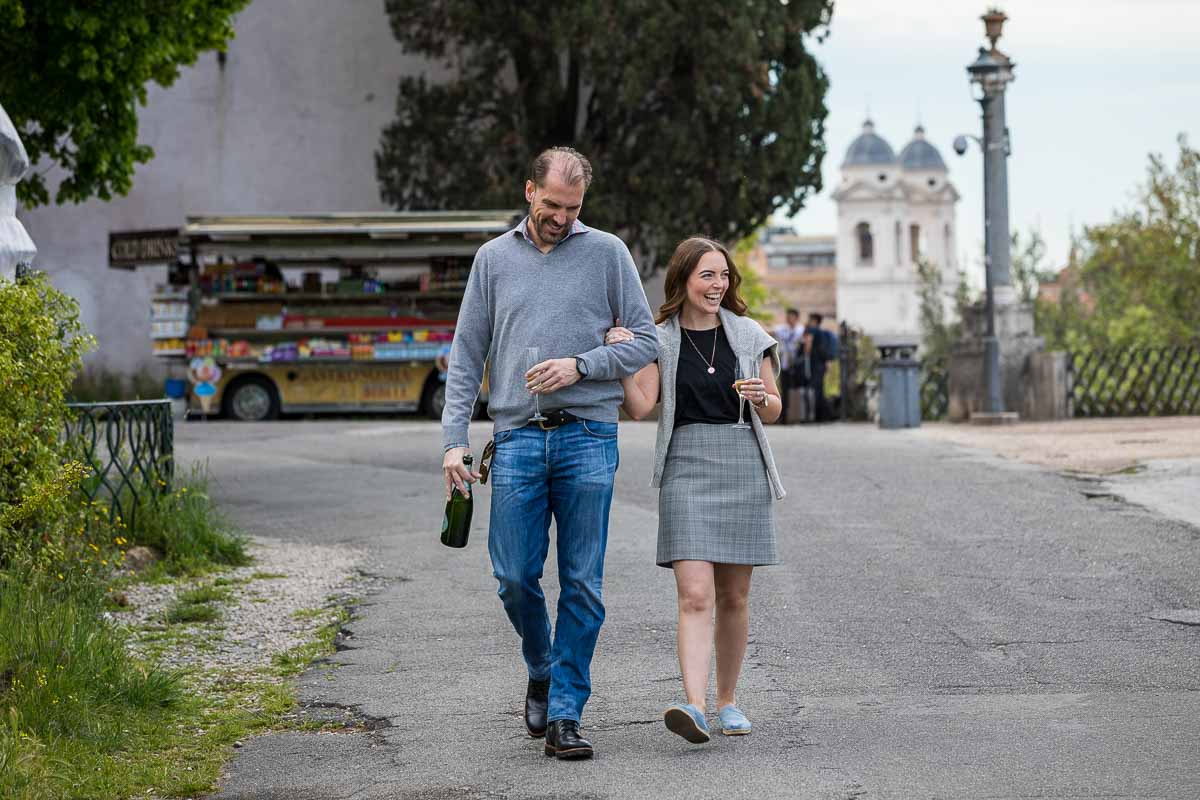 Couple photo session of walking along together with the distant scenic roman scenery