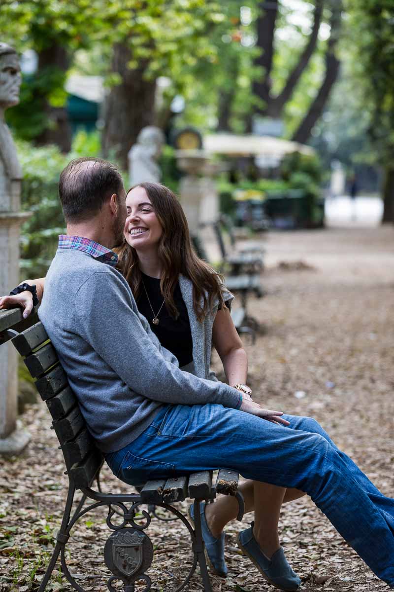 Sitting down portrait laughing and talking together on a park bench