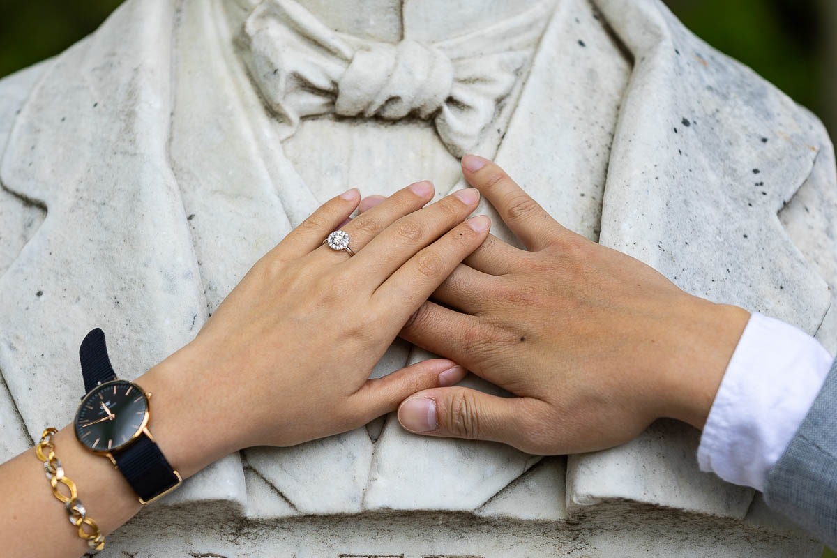 Close up of a couple's hands wearing the engagement ring