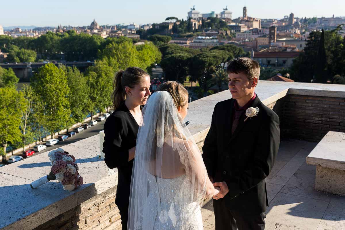 Getting married on the terrace of Giardino degli Aranci in Rome Italy with the city in the background