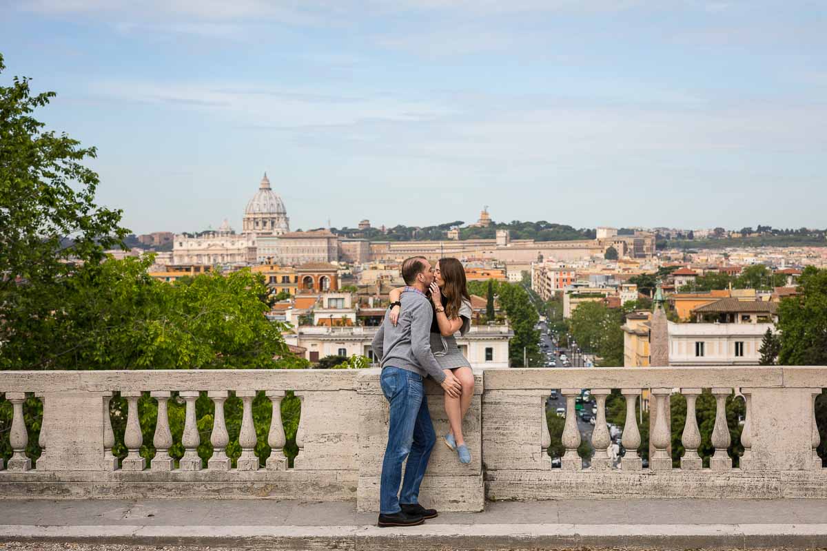 Kissing before the panoramic view of the city of Rome Italy in the background