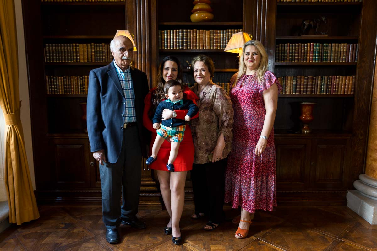 Large family portrait taken in front of the library next to the window shining beautiful soft daylight