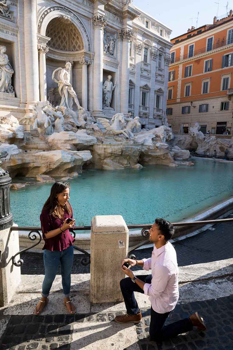 Surprise engagement proposal at the Trevi fountain in Rome Italy