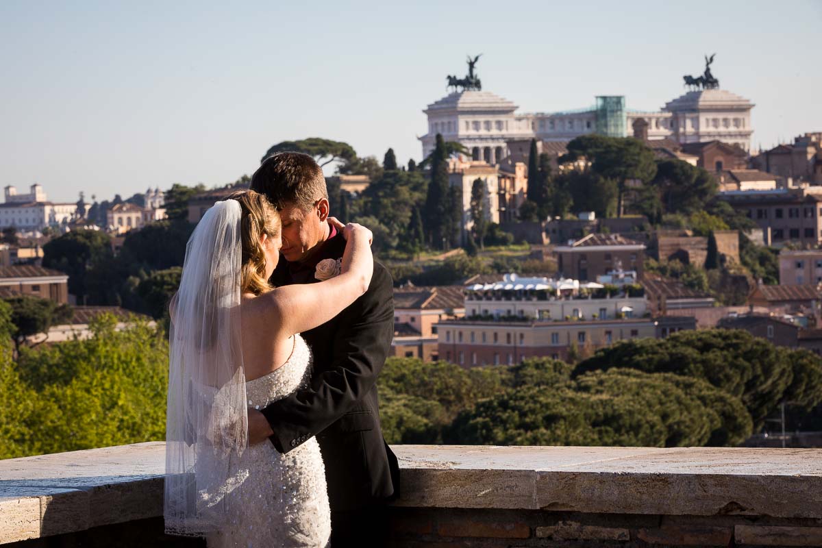 Couple posing wedding attire with the city of Rome in the far distance