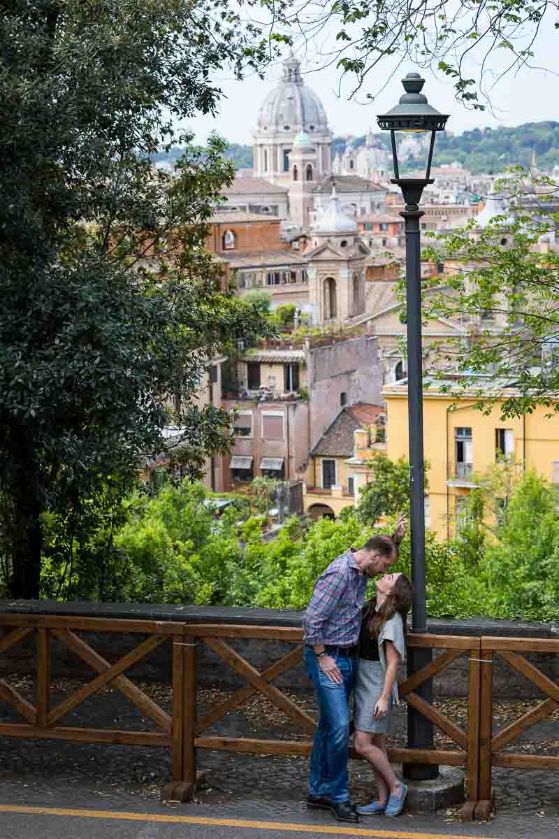 Kissing in Rome with the city view as backdrop