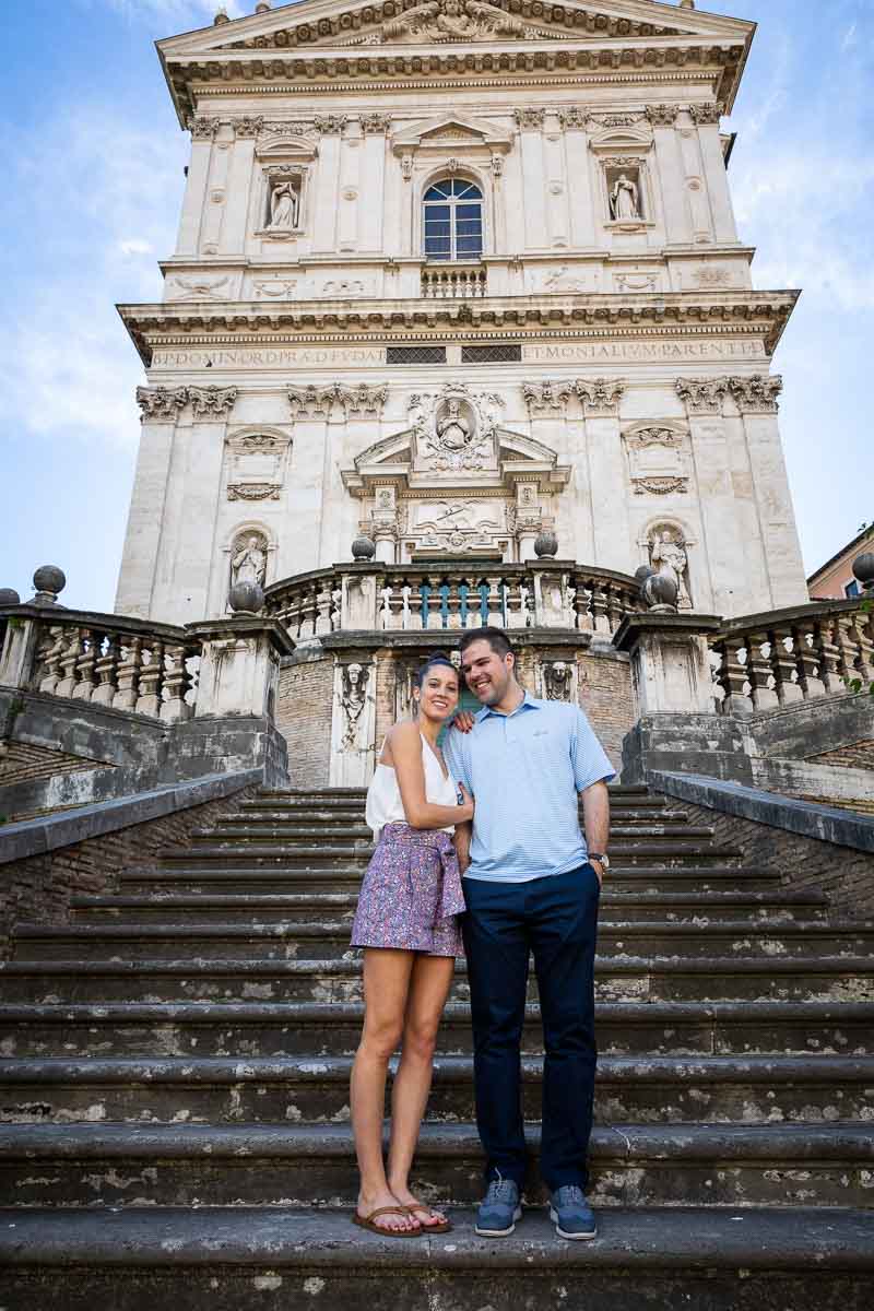 Stand up portrait picture of a couple standing on the beautiful staircase leading to the church facade