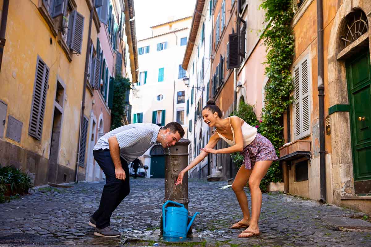 Having fun with a drinking water fountain in the roman streets