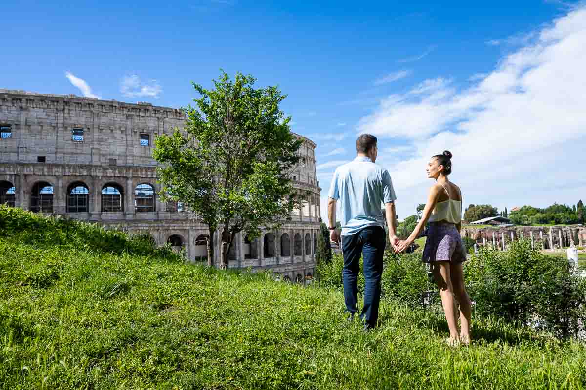 Admiring the roman colosseum from a nearby park with bright green grass