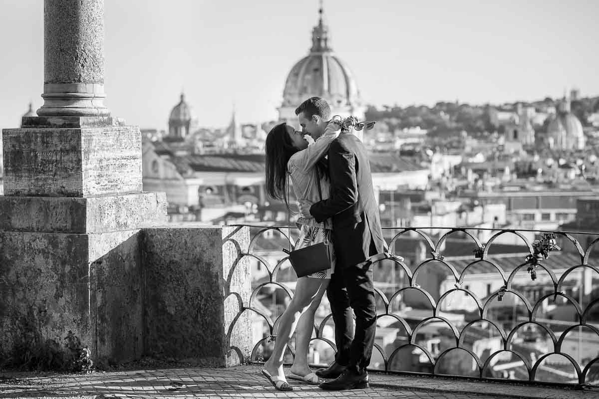 Vertical photo view embracing couple overlooking the roman skyline in black and white photography