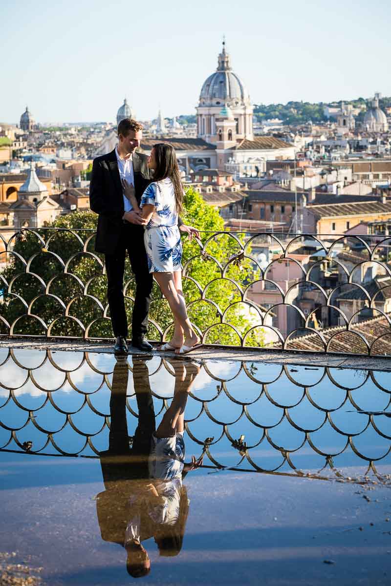 Couple and water puddle reflection at parco del pincio