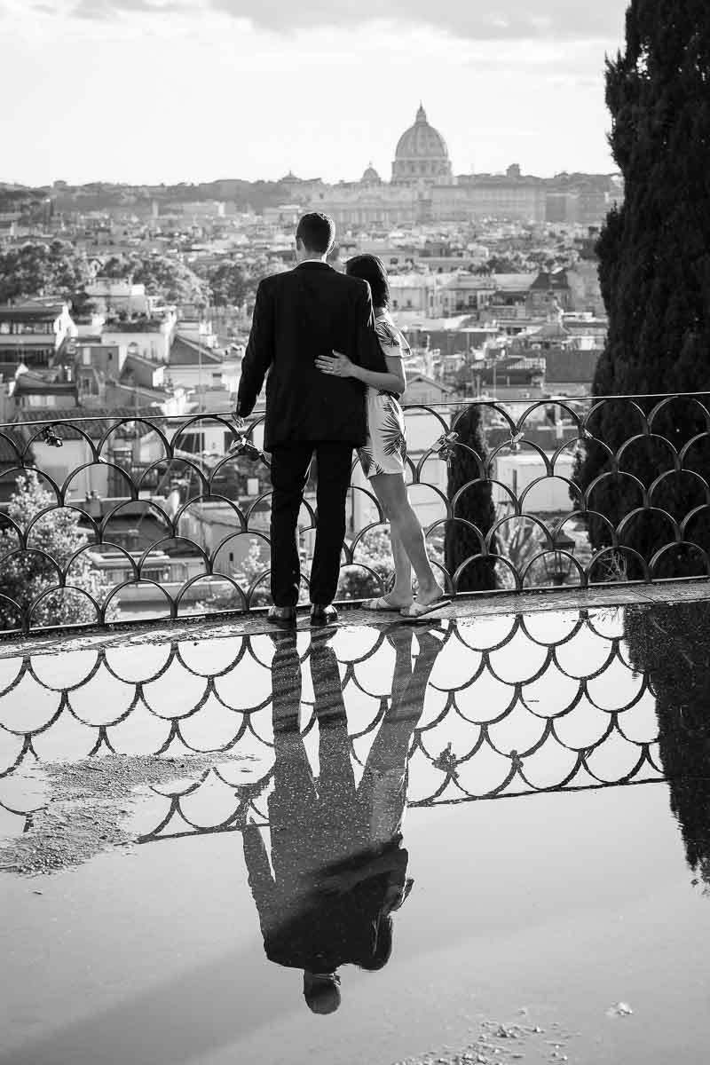 Black and white image of couple overlooking the beautiful and panoramic view of the city of Rome from a terrace view