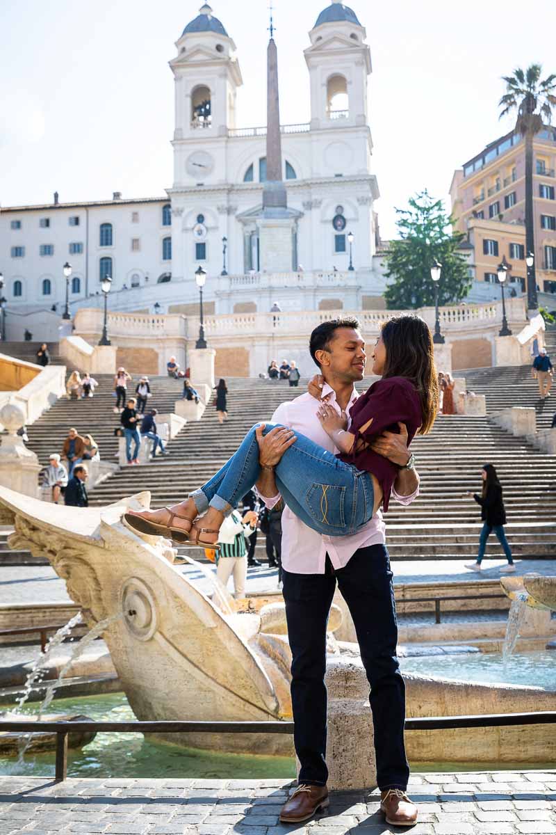 Holding up fiancee in front of the Barcaccia fountain at the base of the Spanishs steps