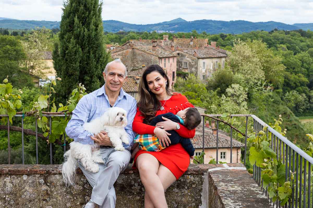 Portrait picture of a family before the Tuscany borgo town in Italy