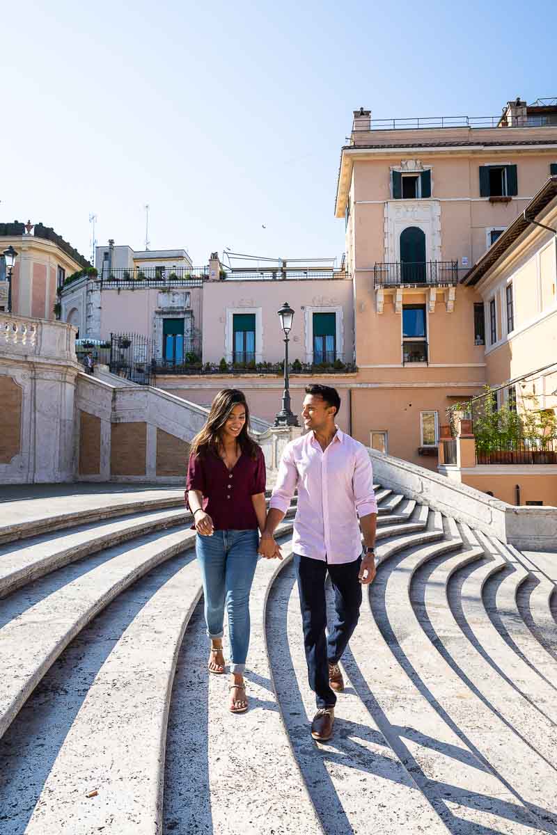 Walking hand in hand together on the steps of Piazza di Spagna