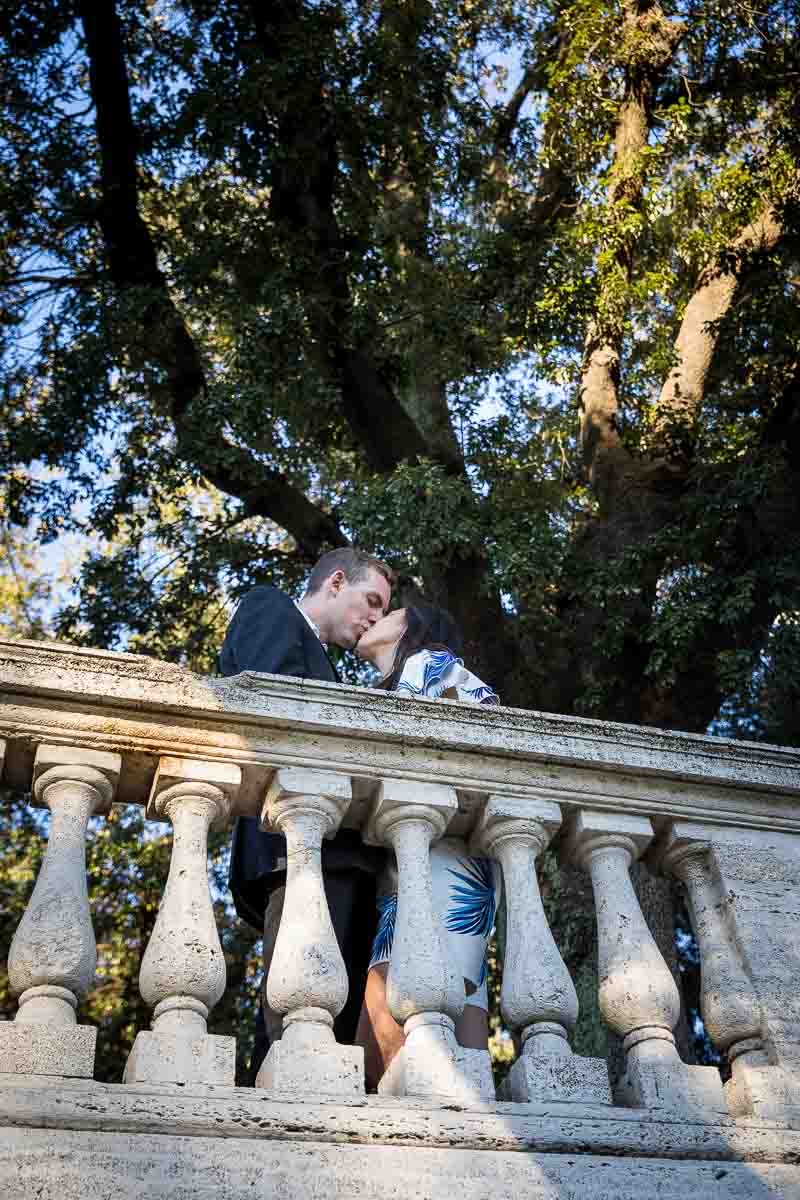 Kissing underneath a tree in the Villa Borghese park