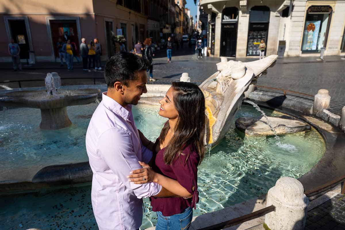 Close together in front of the fountain with beautiful bright colors