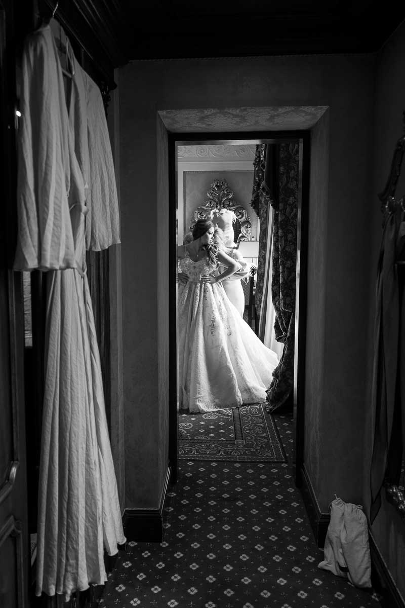 Putting on the wedding dress. b&w image photography