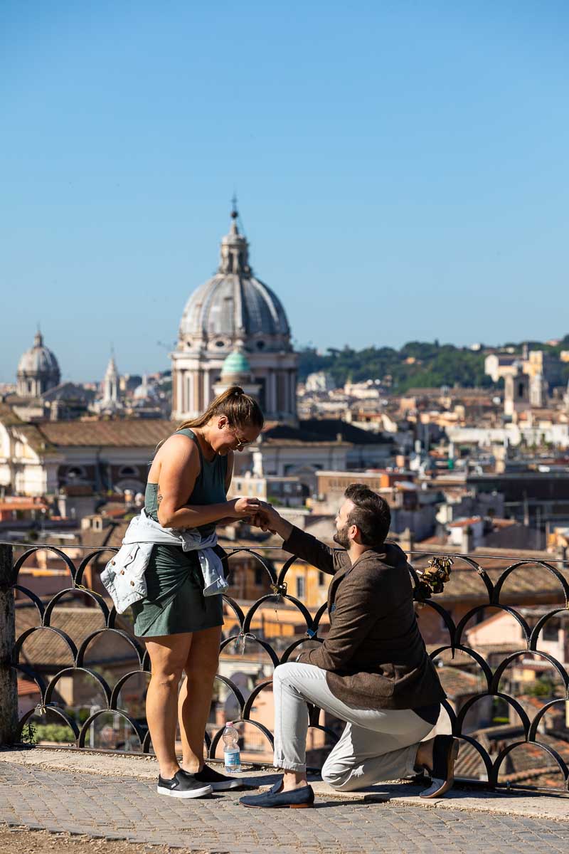 Proposing in Rome. Man down on one knee asking his fiancee in marriage