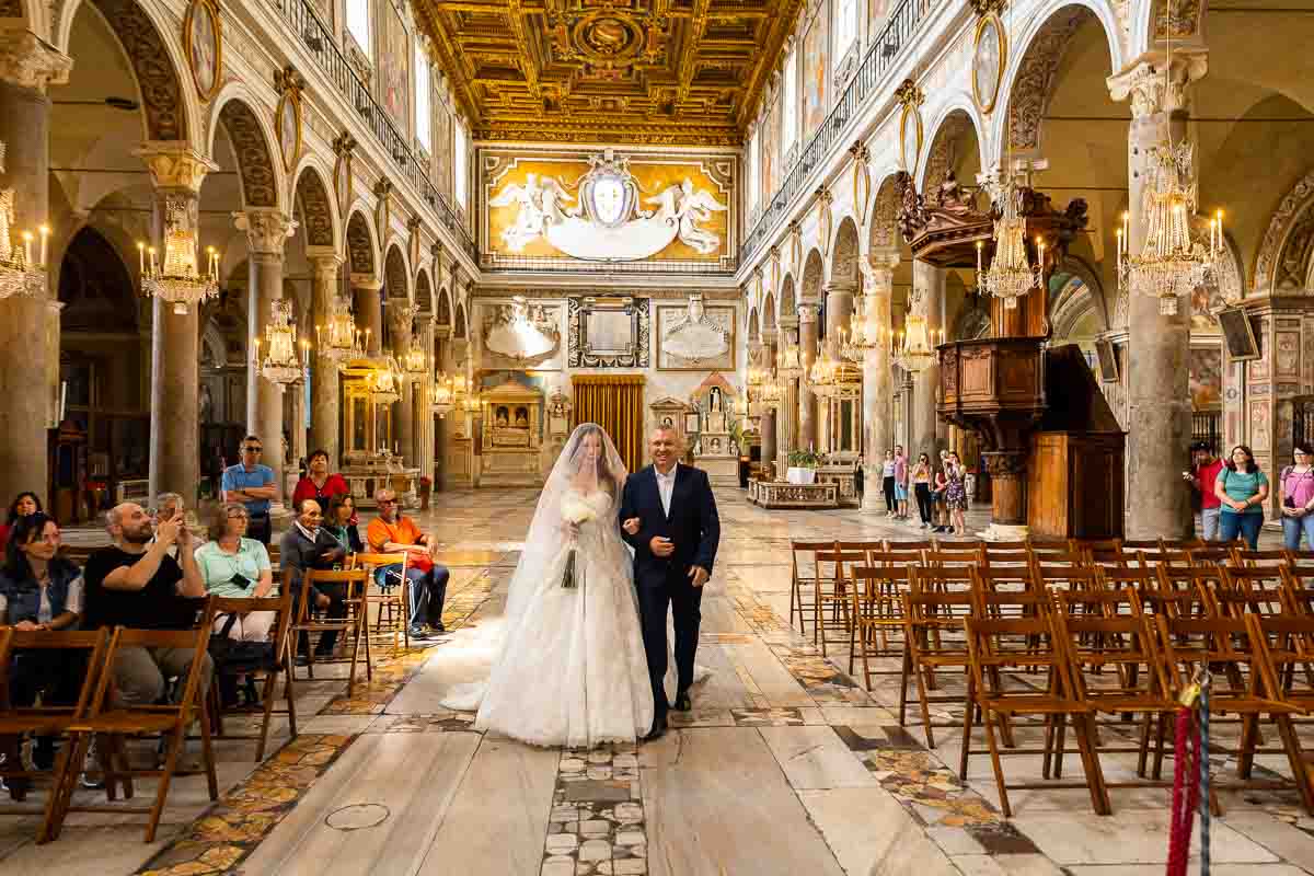 Bride walking down the church hall to reach the altar