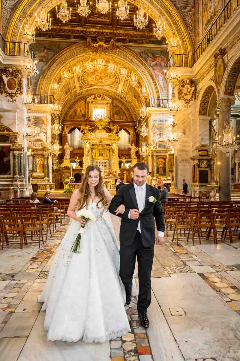 Bride and groom exiting church hall